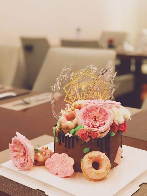 birthday cake and flower arrangements